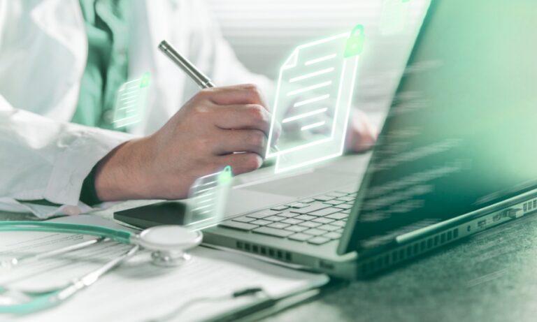 A clinician documenting a patient referral on a laptop