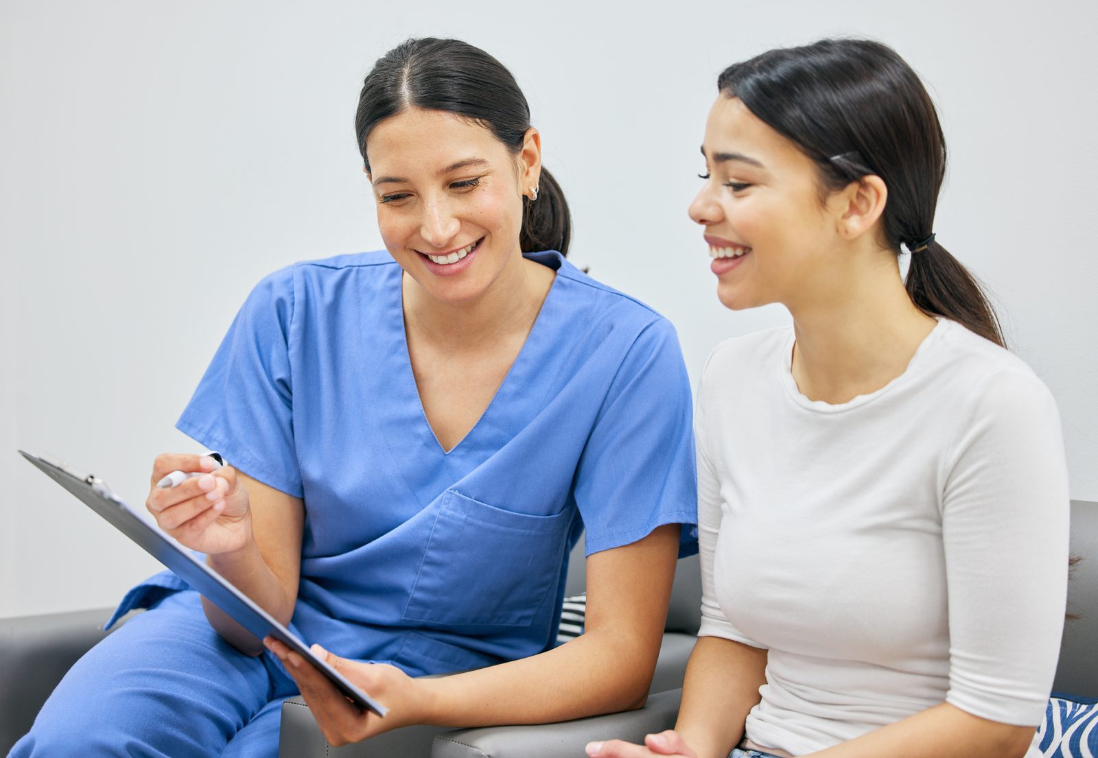 A clinician reviews a care plan with a smiling patient